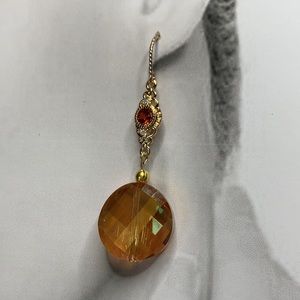 Orange Faceted Glass Dangling Bead hangs from Cubic Zirconia